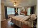 Comfortable bedroom with a decorative fireplace, ceiling fan, and natural light creates a relaxing space at 6616 Love Mill Rd, Monroe, NC 28110