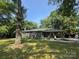 Charming single-story home with a stone front porch and large, shaded front yard at 6616 Love Mill Rd, Monroe, NC 28110