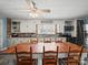 Charming kitchen featuring ample white cabinetry, brick accents, modern appliances, and a dining area at 6616 Love Mill Rd, Monroe, NC 28110