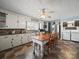 Functional kitchen with a large dining table, granite countertops, white cabinetry, and modern appliances at 6616 Love Mill Rd, Monroe, NC 28110