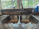 Stainless steel kitchen sink with modern faucet and a stone backsplash under a window with a view at 6616 Love Mill Rd, Monroe, NC 28110