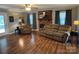 Cozy living room with a brick fireplace, hardwood flooring, and neutral decor at 6616 Love Mill Rd, Monroe, NC 28110