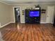 Open-concept living room with hardwood floors, TV console, and an adjacent dining area at 6616 Love Mill Rd, Monroe, NC 28110