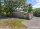 Outbuilding with a metal exterior and sliding door, situated on a gravel drive with a tree in the background at 6616 Love Mill Rd, Monroe, NC 28110