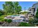 Backyard pool area with lounge chairs and an outdoor kitchen at 711 Yadkin St, Albemarle, NC 28001