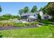 Relaxing backyard featuring a pool, outdoor kitchen, and beautifully landscaped surroundings at 711 Yadkin St, Albemarle, NC 28001