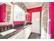 Bright bathroom featuring dual sinks with white cabinets and a separate shower area at 711 Yadkin St, Albemarle, NC 28001