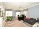 Spacious bedroom with a ceiling fan, two large windows, and neutral carpeting at 711 Yadkin St, Albemarle, NC 28001