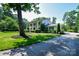 Spacious home with a lush green lawn, mature trees and a long driveway at 711 Yadkin St, Albemarle, NC 28001