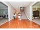 Bright foyer with hardwood floors, staircase, and views into the living room and dining room at 711 Yadkin St, Albemarle, NC 28001