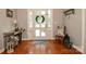 Charming entryway boasts a hardwood floor, a wreath over the front door and decorative furniture at 711 Yadkin St, Albemarle, NC 28001