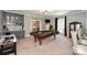 Finished game room with custom wet bar, shelving, an air hockey table, and a pool table at 711 Yadkin St, Albemarle, NC 28001