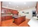 Cherry wood kitchen with large island, marble countertops, hardwood floors, and stainless steel appliances at 711 Yadkin St, Albemarle, NC 28001