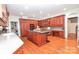 Gourmet kitchen with cherry cabinetry, granite counters, center island, and stainless steel appliances at 711 Yadkin St, Albemarle, NC 28001