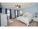 Serene main bedroom with ample natural light, a ceiling fan, and a decorative white bedframe at 711 Yadkin St, Albemarle, NC 28001