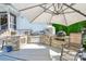 Outdoor kitchen featuring stone counters, built in grill, pizza oven and patio umbrella at 711 Yadkin St, Albemarle, NC 28001