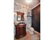 Elegant powder room featuring a decorative mirror, stylish wallpaper, and a classic vanity at 711 Yadkin St, Albemarle, NC 28001