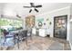 Screened-in porch featuring tile floors, a ceiling fan, a dining table, and an outdoor mini kitchen at 711 Yadkin St, Albemarle, NC 28001