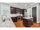 Well-equipped kitchen with stainless appliances, dark wood cabinets, subway tile backsplash and granite countertop island at 739 Terrace Park, Rock Hill, SC 29730