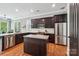 Modern kitchen with stainless steel appliances, granite countertops, and dark wood cabinets at 739 Terrace Park, Rock Hill, SC 29730