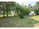 Lush backyard with outbuilding providing shade and privacy at 7645 Robinson Church Rd, Harrisburg, NC 28075