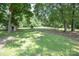 Expansive backyard with grassy lawn and storage shed at 7645 Robinson Church Rd, Harrisburg, NC 28075