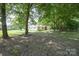 Charming home with blue shutters nestled among mature shade trees at 7645 Robinson Church Rd, Harrisburg, NC 28075