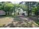Well-maintained backyard with mature trees, offering shade and tranquility at 7645 Robinson Church Rd, Harrisburg, NC 28075