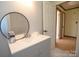 Stylish bathroom with a modern vanity and an adjacent doorway showcasing the home's layout at 7645 Robinson Church Rd, Harrisburg, NC 28075