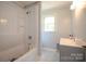 Well-maintained bathroom with a shower-tub combination and a gray vanity at 7645 Robinson Church Rd, Harrisburg, NC 28075