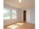 Bright bedroom featuring hardwood floors, natural light, and a closet, creating a comfortable retreat at 7645 Robinson Church Rd, Harrisburg, NC 28075