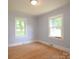 Inviting bedroom boasts hardwood floors and dual windows, creating a sun-filled space at 7645 Robinson Church Rd, Harrisburg, NC 28075