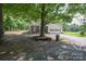 Charming single-story home featuring a covered porch, attached garage, and mature trees in a serene setting at 7645 Robinson Church Rd, Harrisburg, NC 28075