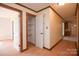 Inviting hallway with neutral walls, wood trim, and access to storage closet at 7645 Robinson Church Rd, Harrisburg, NC 28075