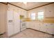 Charming kitchen features white appliances, cabinets, and tile flooring providing a clean and classic feel at 7645 Robinson Church Rd, Harrisburg, NC 28075