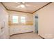 Bright kitchen featuring white cabinetry, tiled floors, and bright window at 7645 Robinson Church Rd, Harrisburg, NC 28075