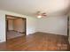 Spacious living room with hardwood floors and neutral wall color at 7645 Robinson Church Rd, Harrisburg, NC 28075