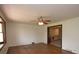 Living room featuring hardwood floors, neutral walls, and modern ceiling fan at 7645 Robinson Church Rd, Harrisburg, NC 28075