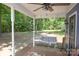 Covered porch with swing and serene backyard views at 7645 Robinson Church Rd, Harrisburg, NC 28075