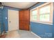 Versatile room with vintage cabinet, natural light, and side door at 7645 Robinson Church Rd, Harrisburg, NC 28075
