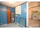 Functional utility room with water heater, storage, and adjacent kitchen access at 7645 Robinson Church Rd, Harrisburg, NC 28075