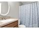Cozy bathroom features a tub with a shower and a granite-look sink vanity at 8266 Knights Bridge Rd, Charlotte, NC 28210