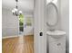 Half bath adjacent to a dining room, featuring modern fixtures and a well-lit mirror at 8266 Knights Bridge Rd, Charlotte, NC 28210