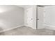 Spacious carpeted bedroom features neutral paint, trim, baseboards, and large closet space at 8266 Knights Bridge Rd, Charlotte, NC 28210
