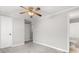 Neutral bedroom featuring a ceiling fan, soft carpet, and a door to an attached bathroom at 8266 Knights Bridge Rd, Charlotte, NC 28210