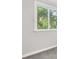 Bedroom featuring neutral carpet, trim, and a window overlooking a tree-filled yard at 8266 Knights Bridge Rd, Charlotte, NC 28210