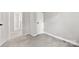 Carpeted bedroom with neutral paint, trim, baseboards, and a view to other rooms at 8266 Knights Bridge Rd, Charlotte, NC 28210