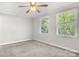 Spacious bedroom with neutral carpet, trim, baseboards, and a natural-light filled window at 8266 Knights Bridge Rd, Charlotte, NC 28210