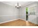 Dining room featuring fresh paint, modern lighting, and an outdoor access door at 8266 Knights Bridge Rd, Charlotte, NC 28210