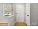 Inviting foyer featuring a bright interior, beautiful floors, and a classic white front door at 8266 Knights Bridge Rd, Charlotte, NC 28210